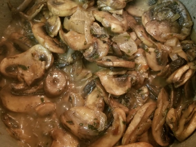 mushrooms and shallots cooking in a pan